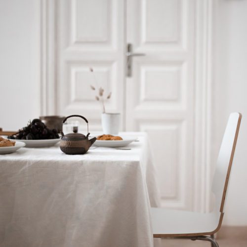 table set with neutral linens and serveware