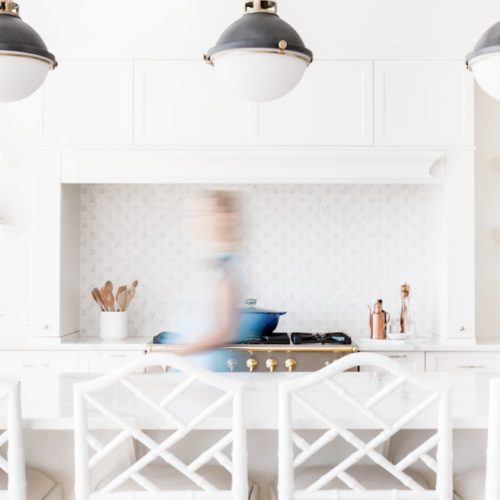 modern white kitchen with island and overhead lighting