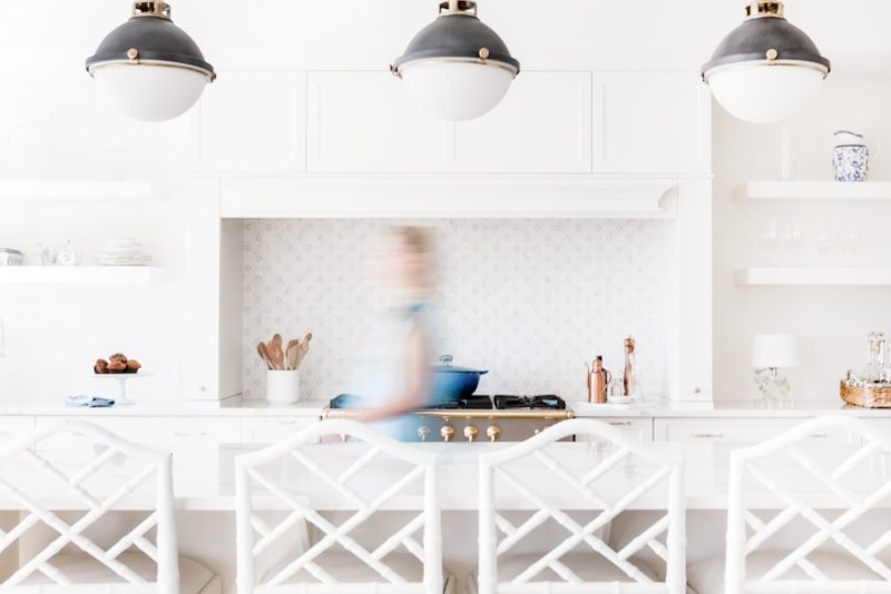 modern white kitchen with island and overhead lighting