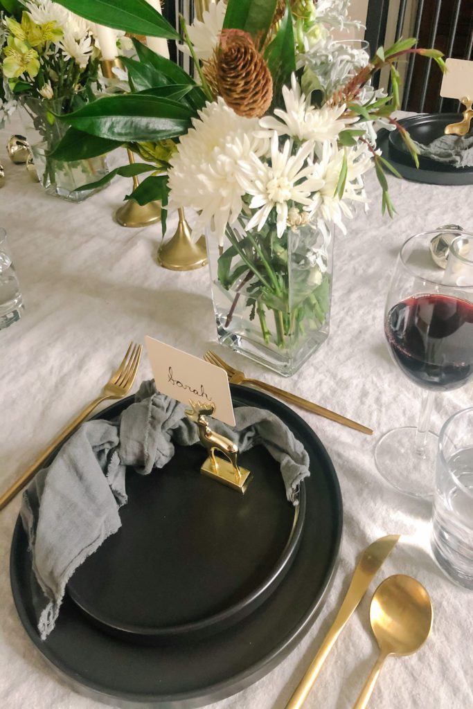 place setting with matte black stoneware plates and matte gold cutlery