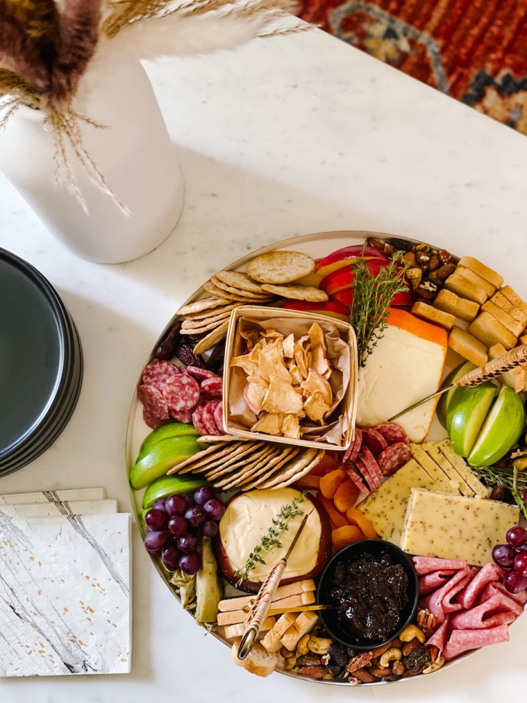 overhead picture of a fall cheese board on a marble coffee table