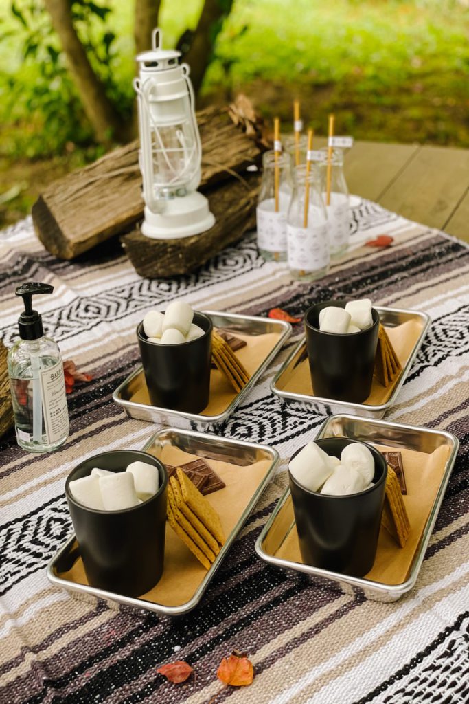 picnic table with camp blanket dessert and lantern