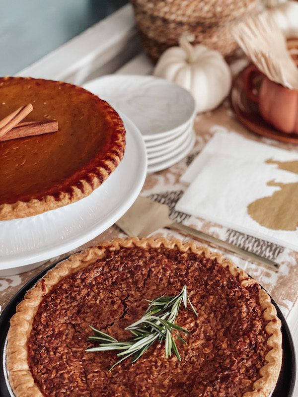 pumpkin pie and pecan pie on a thanksgiving dessert station