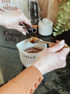adding almond and vanilla extract to hot chocolate