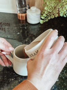 pouring microwaved hot chocolate into mug