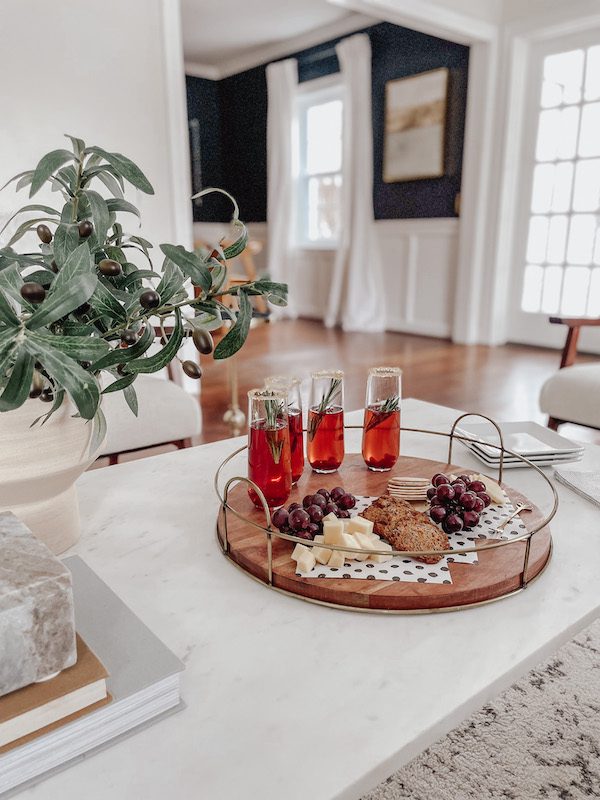 pomegranate mimosas on a marble coffee table in a living room
