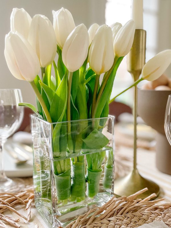 tulip centerpiece on table set for easter brunch