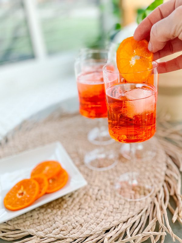 aperol spritz in wine glasses with orange slice garnish